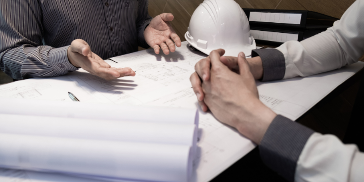 two people reviewing a drawing for construction purposes 