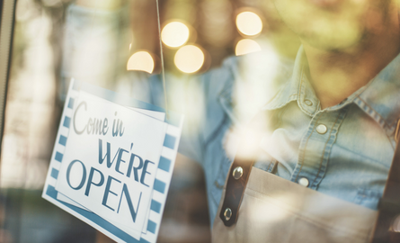 open sign in the window of a business