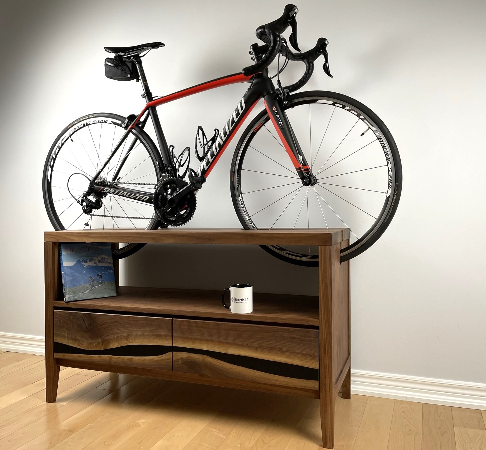 Bike on top of a wooden console 