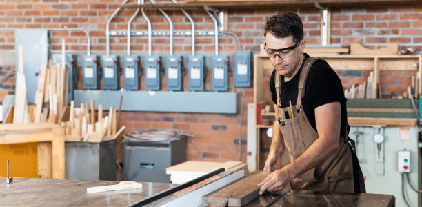 Man at workbench making furniture