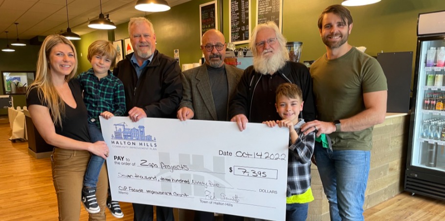 Group of people holding a big cheque