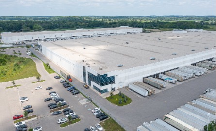 Overhead image of large kraft heinz warehouse with parking lot and busy highway