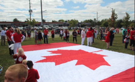 people gathered around Canada flag
