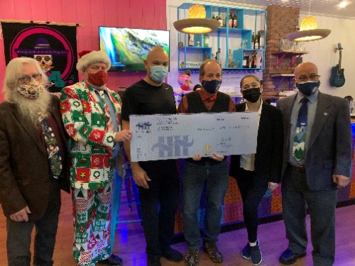 Group of people holding a cheque in a restaurant