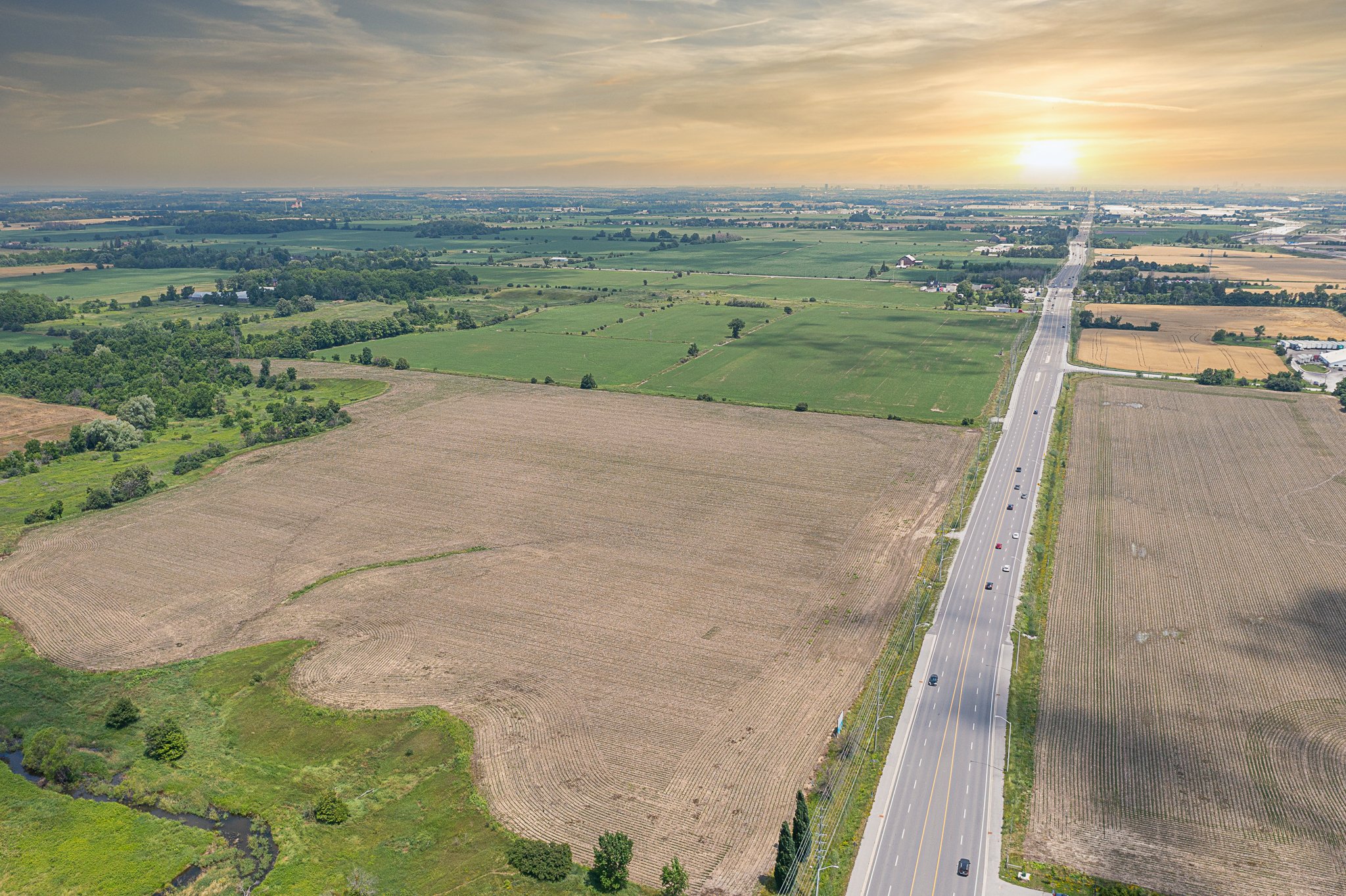 overhead image of vacant lot with green space and sunset