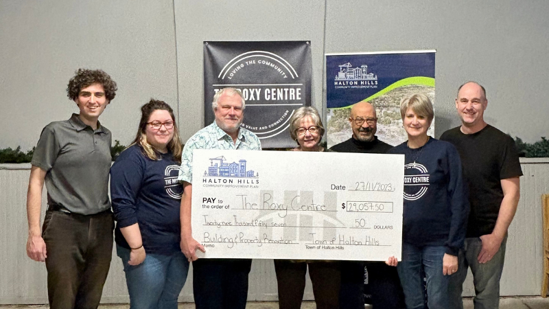 People holding large cheque