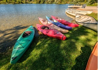 Canoes on grass near lake